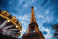 Eiffel tower in Paris against dramatic twilight sky at evening summer time.