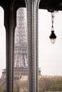 The Eiffel Tower between the pillars of the Bir Hakeim bridge in Paris on a cloudy cold winter day Royalty Free Stock Photo