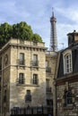 The Eiffel Tower seen behind buildings in Paris, France