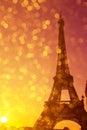 Eiffel Tower silhouette at sunset in Paris France with shiny golden bokeh lights Royalty Free Stock Photo