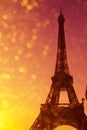 Eiffel Tower silhouette at sunset in Paris France with shiny golden bokeh lights Royalty Free Stock Photo