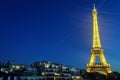 The Eiffel Tower Tour Eiffel lit up against a dark blue sky.