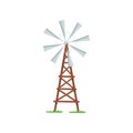 Eight-bladed wind pump used to pumping water from the ground. Old farm windmill on wooden tower. Agricultural Royalty Free Stock Photo