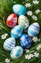 eight colorful Easter eggs uniquely decorated with detailed patterns and designs in green grass with daisies, top view Royalty Free Stock Photo