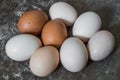 Eight fresh chicken eggs on an old wooden background