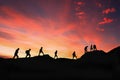 Eight friends walk on mountain path in sunset