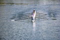 Eight men rowing