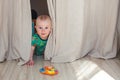 Eight month baby boy playing hide and seek Royalty Free Stock Photo