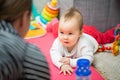 Eight months old baby girl laying on the floor Royalty Free Stock Photo