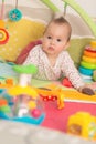 Eight months old baby girl playing with colorful toys Royalty Free Stock Photo