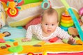 Eight months old baby girl playing with colorful toys Royalty Free Stock Photo