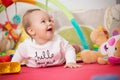 Eight months old baby girl playing with colorful toys Royalty Free Stock Photo