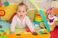 Eight months old baby girl playing with colorful toys Royalty Free Stock Photo