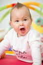 Eight months old baby girl playing with colorful toys Royalty Free Stock Photo