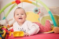 Eight months old baby girl playing with colorful toys Royalty Free Stock Photo