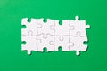 Eight pieces white jigsaw puzzle on green background for business presentation Royalty Free Stock Photo