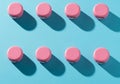 Eight pink caps arranged in two rows on a blue background Royalty Free Stock Photo