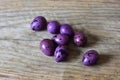 Eight purple quail eggs on a wooden background. Top view of quail eggs with shell. Royalty Free Stock Photo