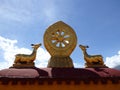 Eight-spoked Dharma wheel on lotus flower, flanked by a pair of deer on the roof of Jokhang Monastery, Lhasa, Tibet Royalty Free Stock Photo