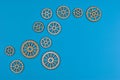 Eight wooden gears on blue surface illustrate mechanical interconnectivity Royalty Free Stock Photo
