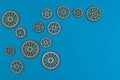 Eight wooden gears on blue surface illustrate mechanical interconnectivity Royalty Free Stock Photo