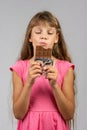 Eight-year-old girl with pleasure eats chocolate bar