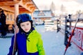 Eight years old boy in helmet on ski slope. Royalty Free Stock Photo