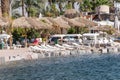 Couches and umbrellas on the beach of Eilat Royalty Free Stock Photo