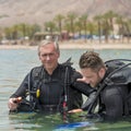 Eilat, Israel - May 2018: School of divers. Men are training in diving. Teamwork in a pair. Close up