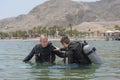 Eilat, Israel - May 2018: School of divers. Men are training in diving. Teamwork in a pair
