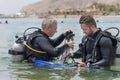 Eilat, Israel - May 2018: School of divers. Men are training in diving. Two divers in basic equipment Royalty Free Stock Photo