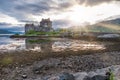 Eilean Donan Castle during sunset while canoes passing by - Dornie, Scotland Royalty Free Stock Photo