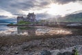 Eilean Donan Castle during sunset while canoes passing by - Dornie, Scotland Royalty Free Stock Photo