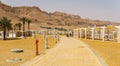 EIN BOKEK, ISRAEL - March 28, 2018: Solar beach on the Dead Sea with beach sunshades . Royalty Free Stock Photo