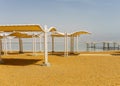 EIN BOKEK, ISRAEL - March 28, 2018: Solar beach on the Dead Sea with beach sunshades . Royalty Free Stock Photo