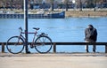 A cyclist takes a break on the banks of the Danube