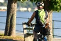 A cyclist with a dog in the back seat