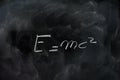 Einstein relativity formula e=mc2 on black chalk board