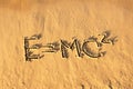 Einstein's formula handwriting on the sand. Royalty Free Stock Photo
