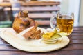 Eisbein with bread, vegetables and beer on wooden cutting board Royalty Free Stock Photo