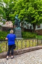 Eisenach, Germany - May 28, 2019: Tourists pose with the statue of J.S. Bach outside the house where the famous composer and