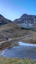 Eisenerzer Reichenstein - A woman in front of a frozen lake near Eisenerz in Styria, Austria Royalty Free Stock Photo