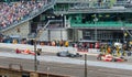 EJ Viso, Tony Kanaan, and Helio Castroneves entering the pit.