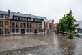 Ekeren, Antwerp province, Belgium - Old village square with wet cobble stones in the rain Royalty Free Stock Photo