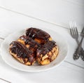 Ekler Pasta / Chocolate Donut in plate on white background Royalty Free Stock Photo