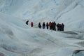 A group of crampons wearing tourists trekking on Perito Moreno Glacier in the Los Glaciares National Park