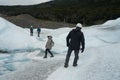A group of crampons wearing tourists trekking on Perito Moreno Glacier in the Los Glaciares National Park