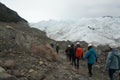 A group of crampons wearing tourists trekking on Perito Moreno Glacier in the Los Glaciares National Park