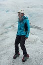 A mountain guide helps ice trekking tourists on Perito Moreno Glacier in the Los Glaciares National Park Royalty Free Stock Photo