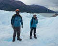 A mountain guides help ice trekking tourists on Perito Moreno Glacier in the Los Glaciares National Park Royalty Free Stock Photo